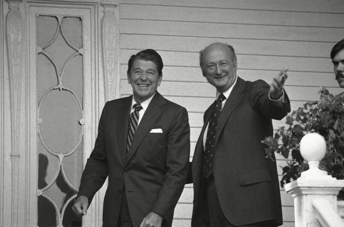 Mayor Ed Koch gestures towards newsmen as he escorts Republican presidential nominee Ronald Reagan into Gracie Mansion. 1980.